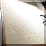 D09b. Tan colored wool rug with leather banding on edge. 8' x 8' - $395